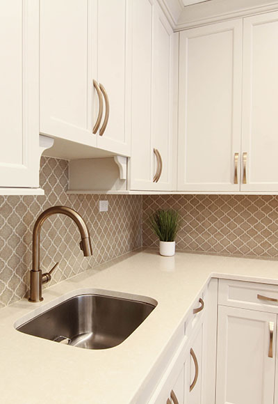 vanilla kitchen cabinet with rustic faucet