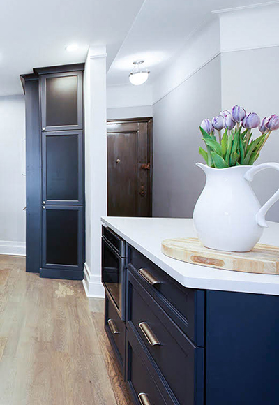 navy blue kitchen with white counter with stainless steel handle